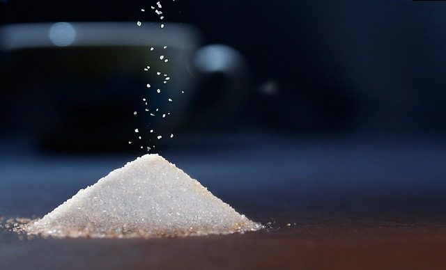 Sugar cubes stacked on a wooden surface