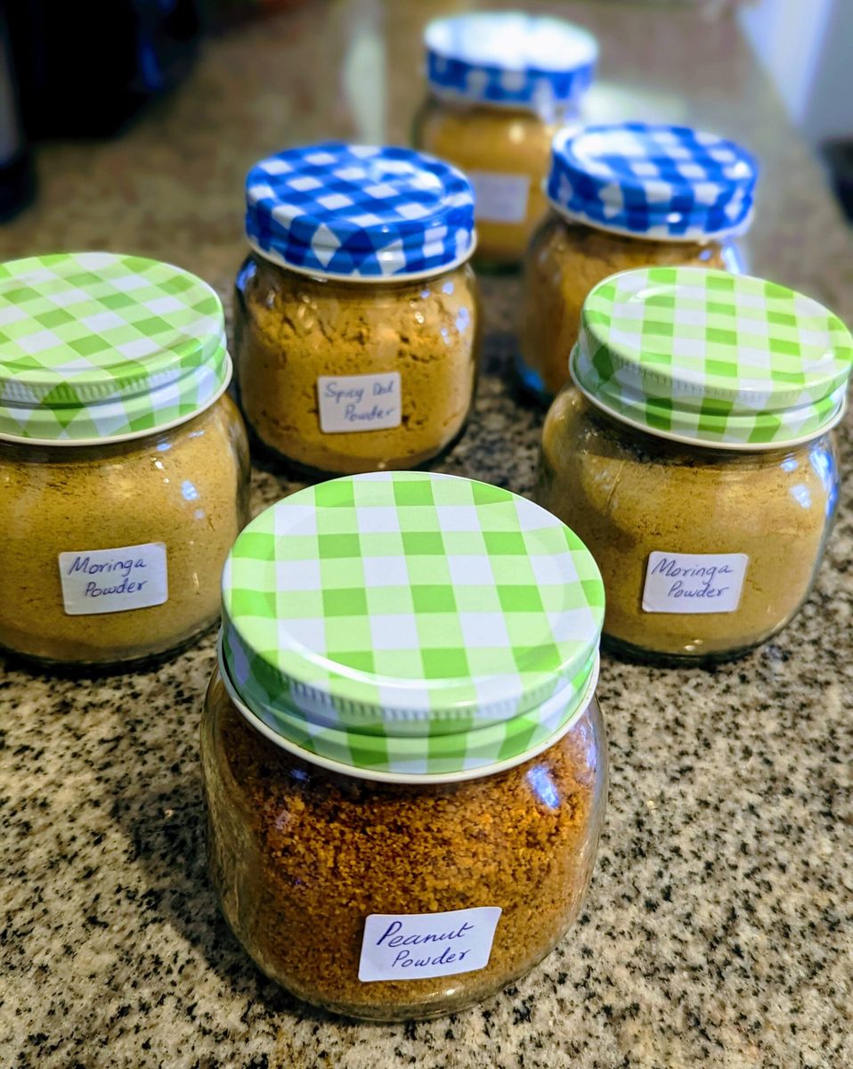Several jars of Mrukku Bites spicy lentil powder in different flavours